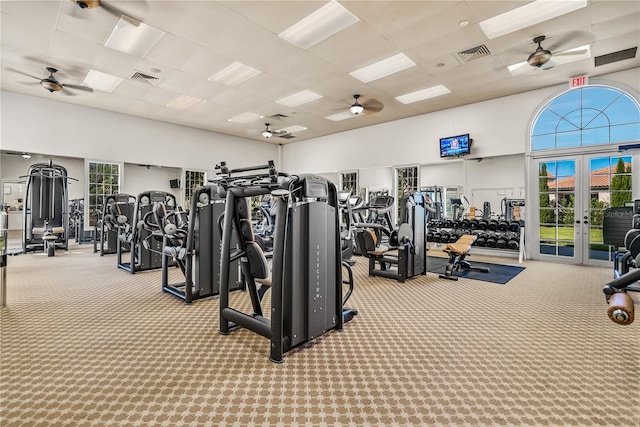 workout area with ceiling fan, a paneled ceiling, and carpet