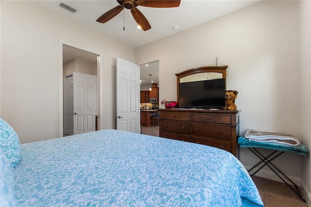 bedroom featuring connected bathroom and ceiling fan