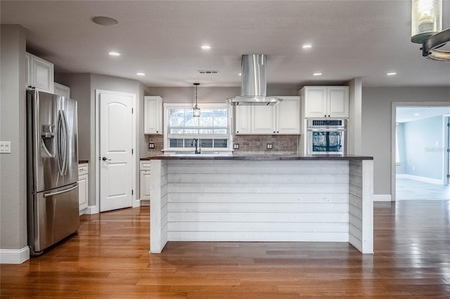 kitchen with white cabinets, sink, hanging light fixtures, island exhaust hood, and stainless steel appliances