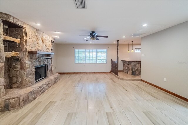 unfurnished living room featuring a fireplace, light hardwood / wood-style flooring, and ceiling fan