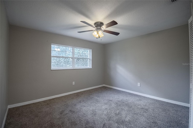 spare room featuring carpet flooring, a textured ceiling, and ceiling fan