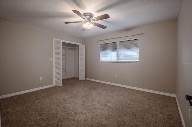 unfurnished bedroom with carpet flooring, a textured ceiling, a closet, and ceiling fan