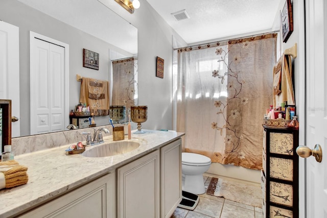 full bathroom with a textured ceiling, vanity, shower / tub combo with curtain, tile patterned flooring, and toilet