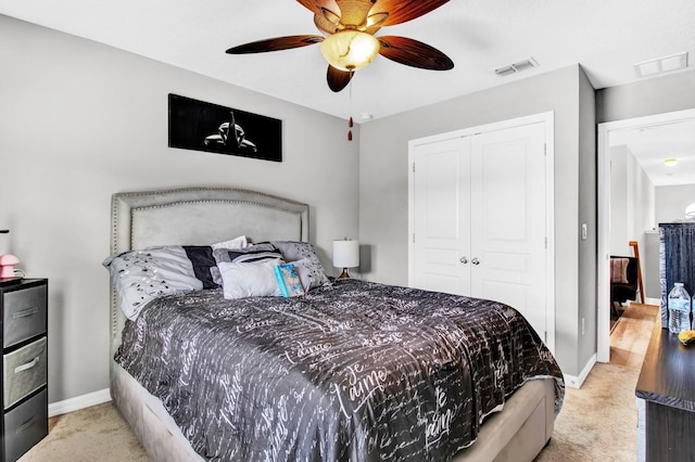 carpeted bedroom with a closet and ceiling fan