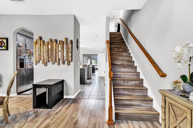 stairs featuring hardwood / wood-style floors