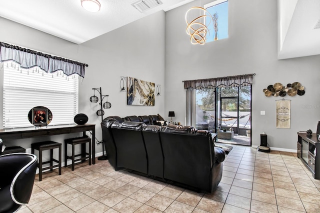 living room featuring light tile patterned floors and a towering ceiling