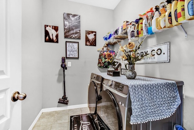 laundry room featuring tile patterned floors and washing machine and clothes dryer