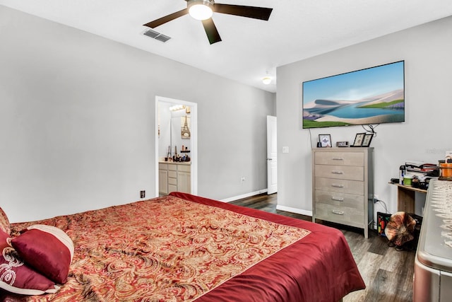 bedroom with dark hardwood / wood-style flooring, ensuite bath, and ceiling fan