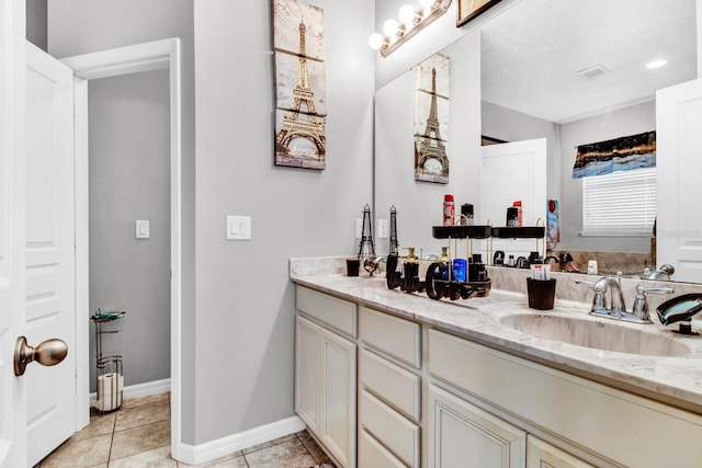 bathroom with tile patterned flooring and vanity