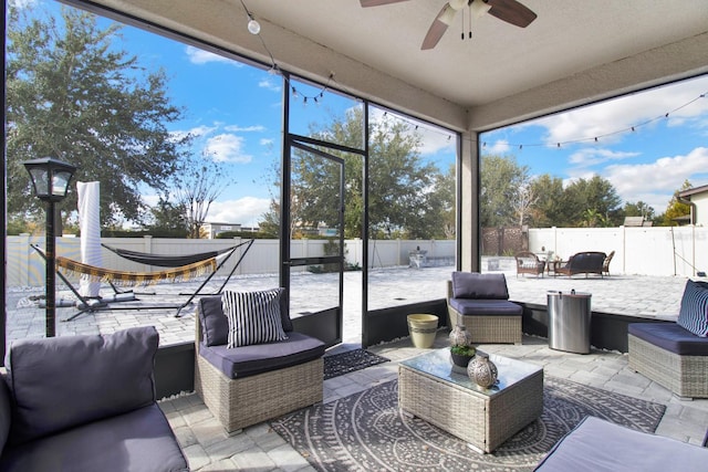 sunroom / solarium featuring ceiling fan