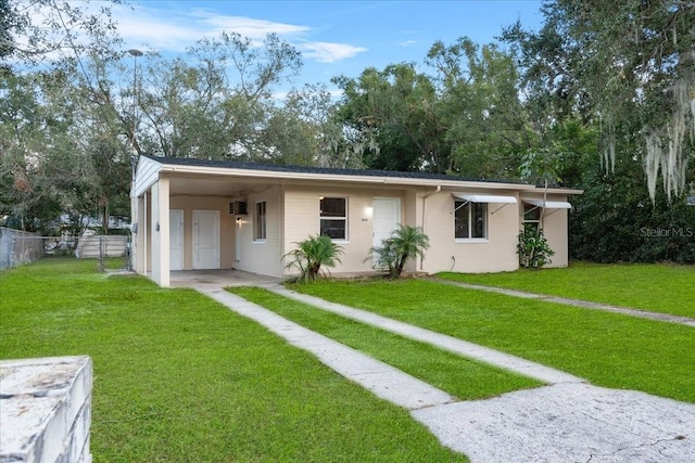 view of front of house featuring a front lawn and a carport