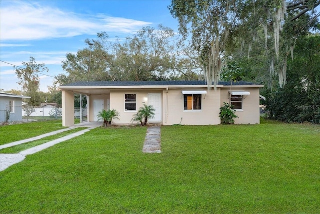 ranch-style house with a front lawn and a carport