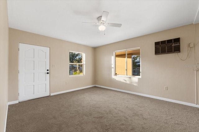 carpeted spare room featuring ceiling fan and a wall mounted AC