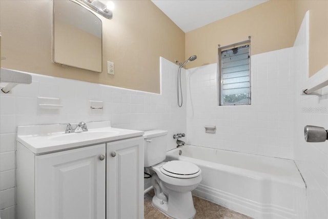 full bathroom with vanity, toilet, tile walls, and tiled shower / bath combo