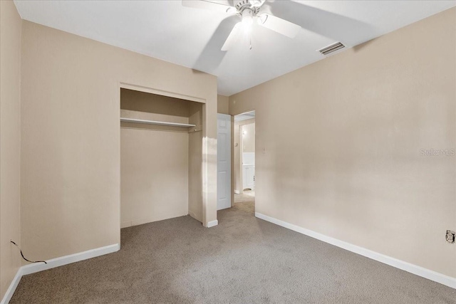 unfurnished bedroom with ceiling fan, carpet floors, and a closet