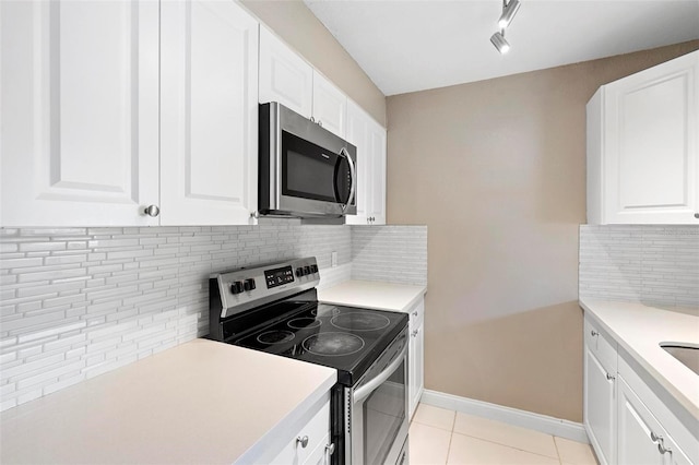 kitchen with white cabinets and appliances with stainless steel finishes