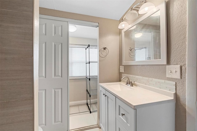 bathroom with tile patterned flooring and vanity