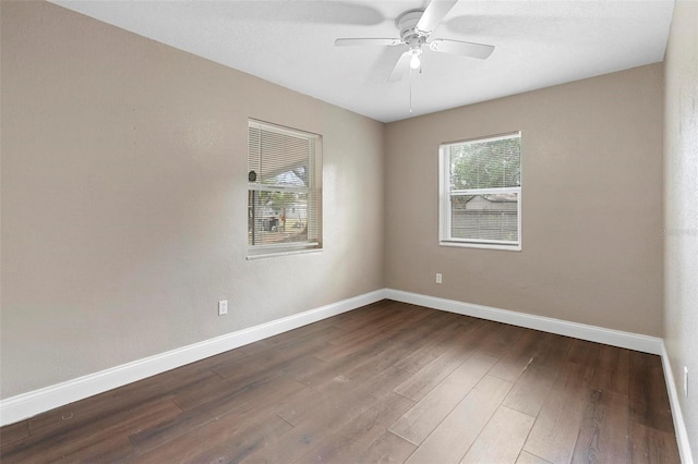 spare room featuring dark hardwood / wood-style floors and ceiling fan