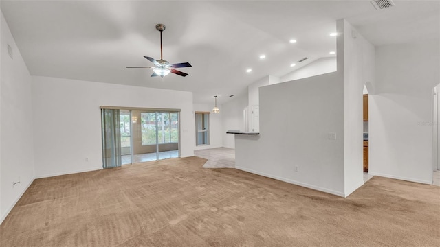 unfurnished living room featuring light colored carpet, vaulted ceiling, and ceiling fan