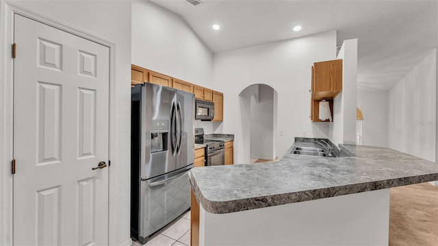 kitchen featuring sink, stainless steel appliances, kitchen peninsula, lofted ceiling, and light tile patterned floors