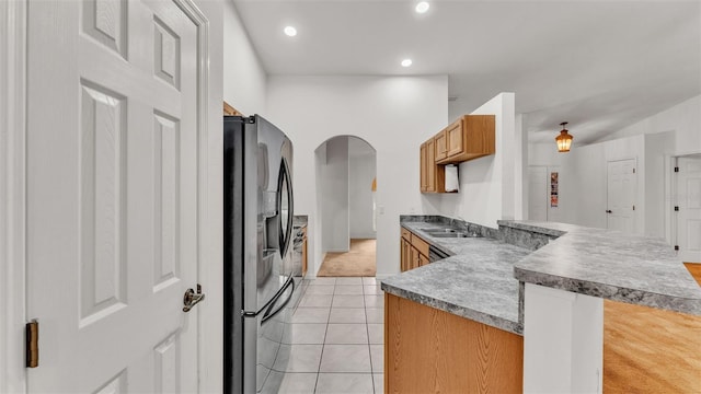 kitchen featuring sink, stainless steel refrigerator with ice dispenser, and light carpet