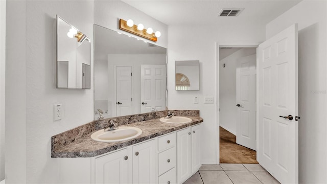 bathroom featuring tile patterned flooring and vanity