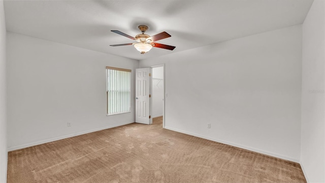 spare room featuring ceiling fan and light colored carpet