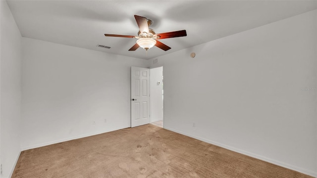 carpeted spare room featuring ceiling fan