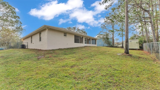 back of house with a lawn and central AC