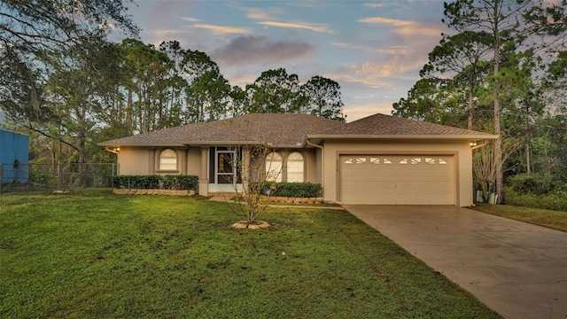 view of front of property featuring a yard and a garage