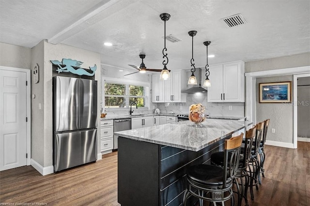 kitchen featuring white cabinets, hardwood / wood-style floors, and stainless steel appliances