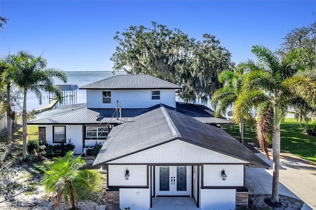 back of house with a water view and french doors