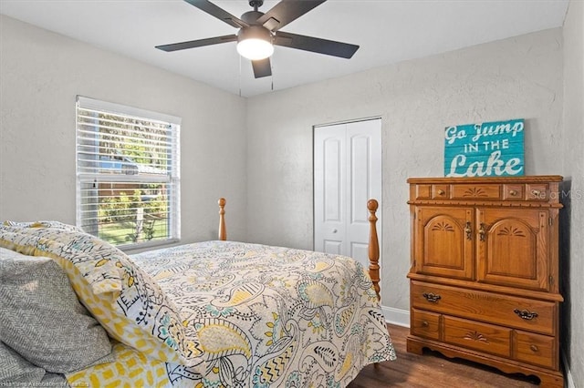 bedroom with wood-type flooring, a closet, and ceiling fan