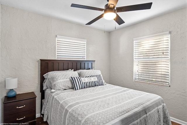 bedroom with multiple windows and ceiling fan