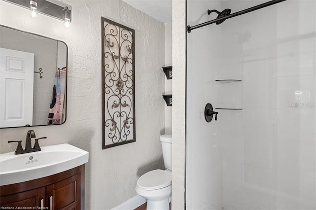 bathroom with vanity, toilet, and walk in shower