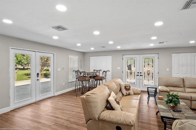 living room with light hardwood / wood-style floors and french doors