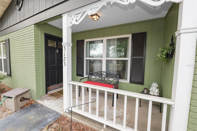 view of exterior entry with covered porch