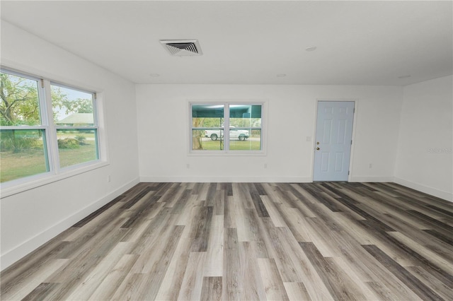 spare room with hardwood / wood-style floors