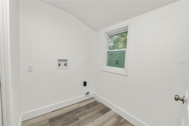 laundry area with hookup for an electric dryer, hookup for a washing machine, and light hardwood / wood-style floors