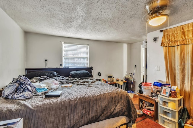 bedroom with a textured ceiling and ceiling fan