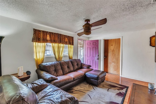 living room featuring a textured ceiling, hardwood / wood-style flooring, and ceiling fan