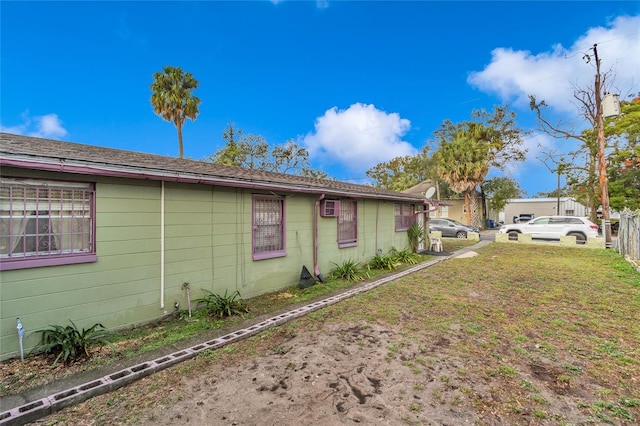 view of side of home featuring a yard