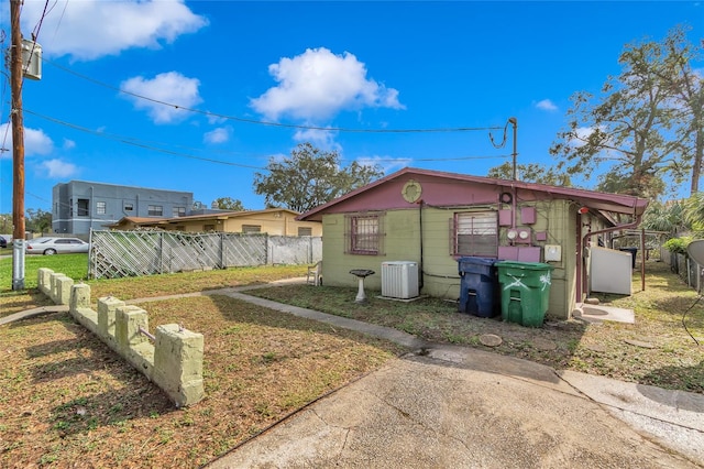 view of home's exterior featuring a yard and cooling unit