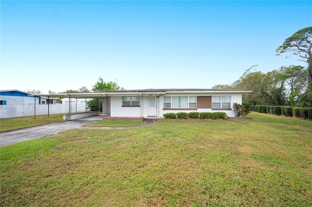 ranch-style home with a carport and a front lawn