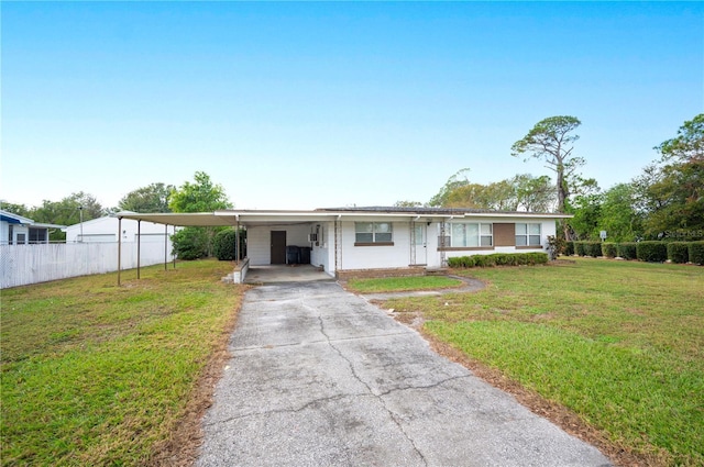 view of front of home with a front yard and a carport