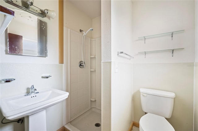 bathroom featuring walk in shower, sink, and toilet