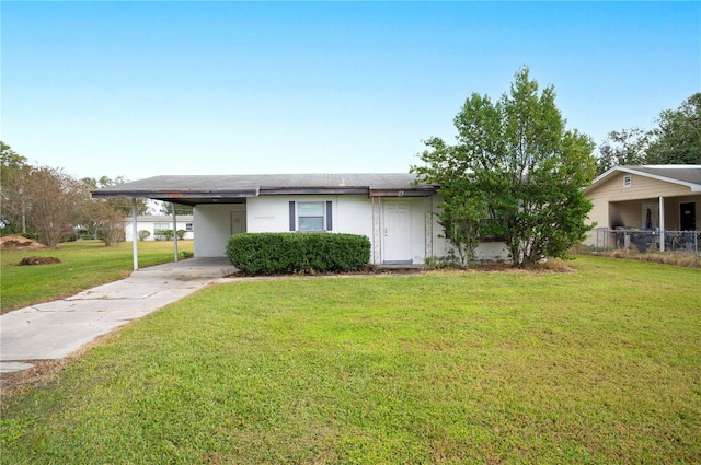 ranch-style house with a front yard and a carport