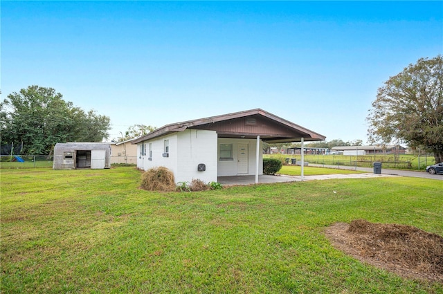 exterior space featuring a lawn and an outbuilding