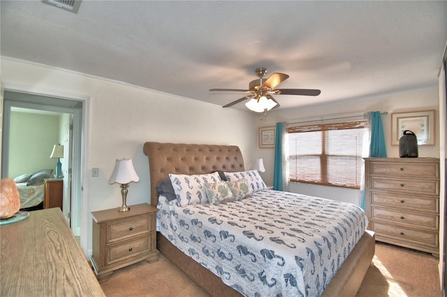 carpeted bedroom with a textured ceiling and ceiling fan