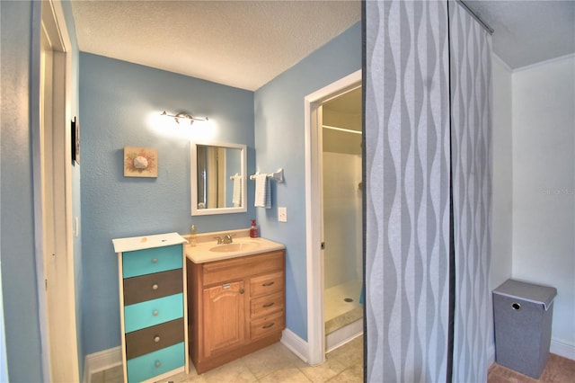 bathroom featuring a shower, a textured ceiling, vanity, and tile patterned floors